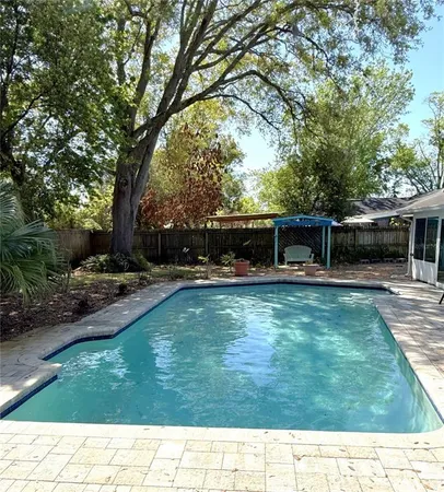 a large kitchen with stainless steel appliances kitchen island granite countertop a refrigerator and a stove top oven