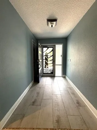 an empty room with a ceiling fan and carpet