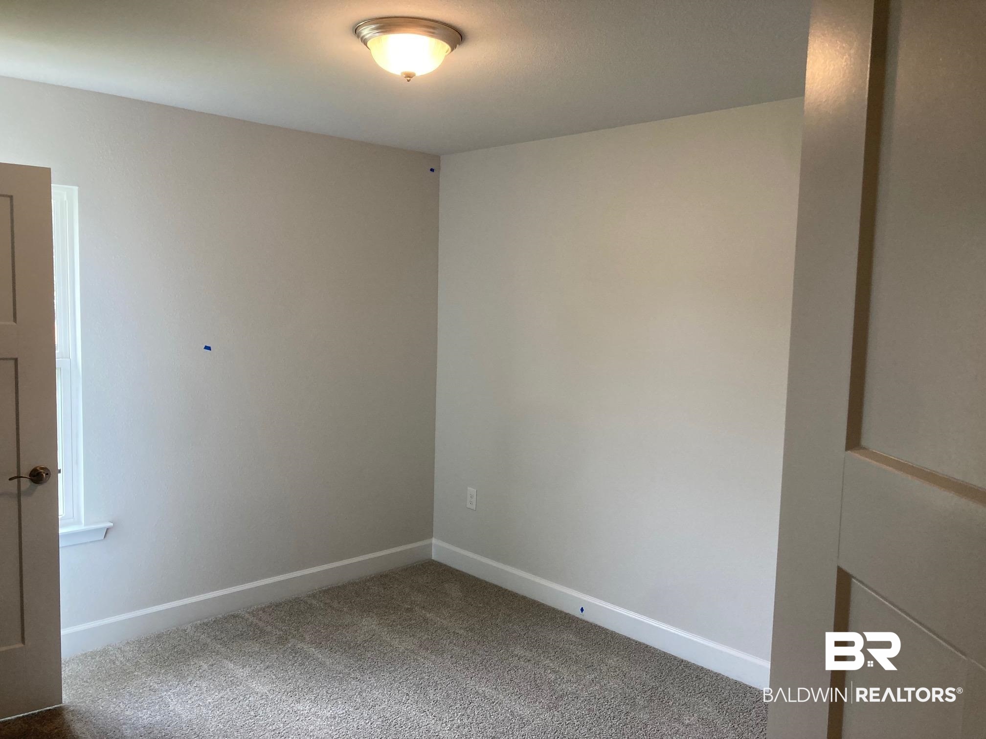 705 Mayflower Drive Foley, AL 36535 - Photo 15 of 19 Carpeted empty room with baseboards