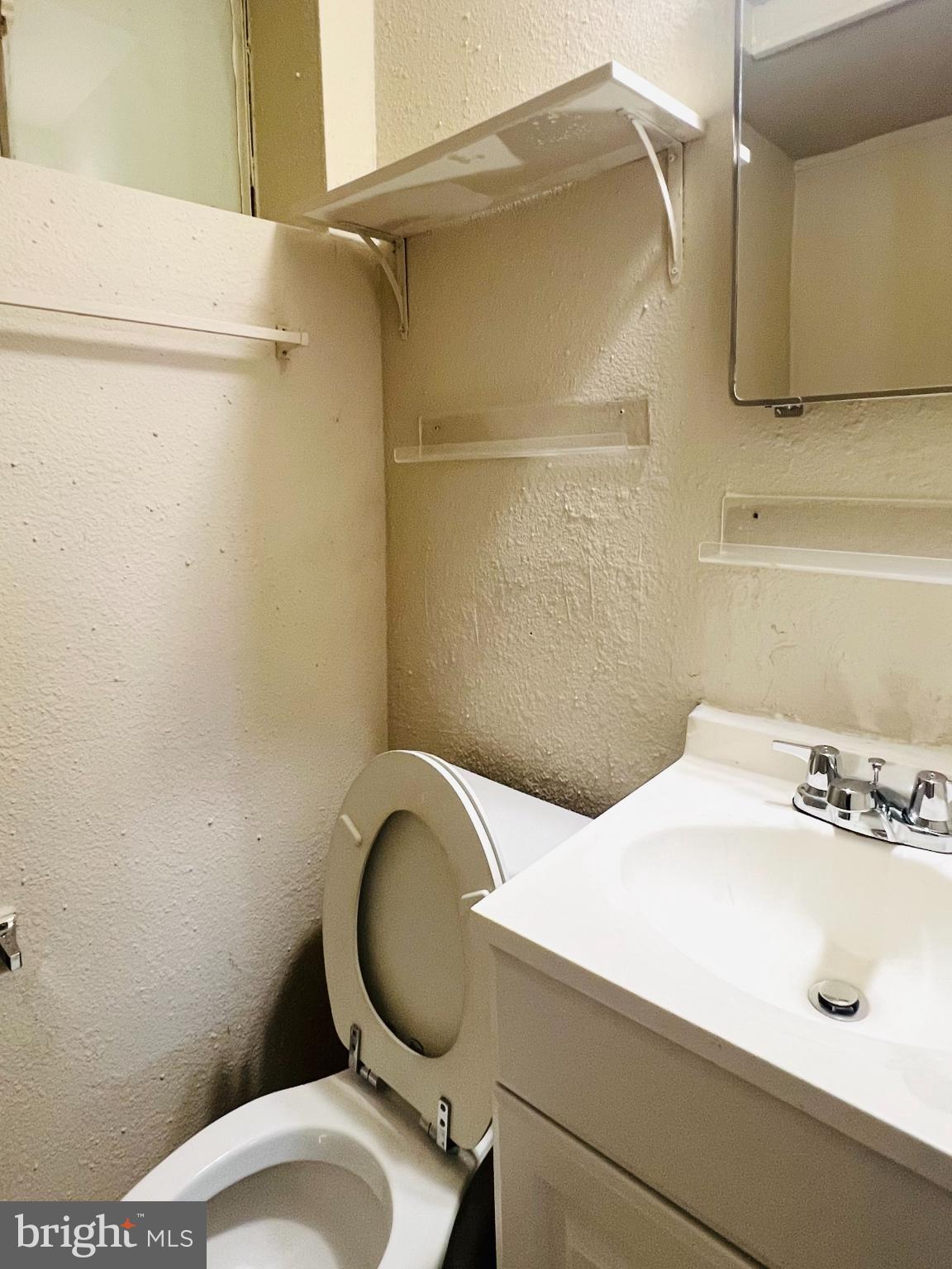 4901 Fitch Place Northeast Washington, DC 20019 - Photo 32 of 47 a bathroom with a sink a toilet and shower