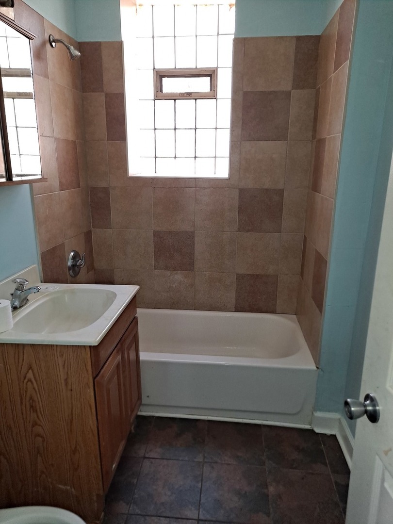1640 South Springfield Avenue Chicago, IL 60623 - Photo 5 of 11 a bathroom with a sink and a bathtub