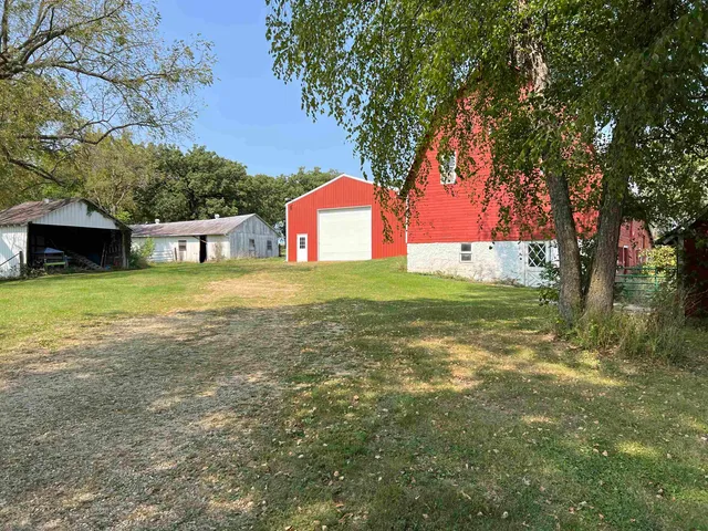 a view of yard with swimming pool and trees