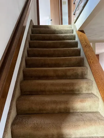an empty room with wooden floor and closet