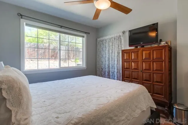 a bedroom with a large bed and a flat screen tv