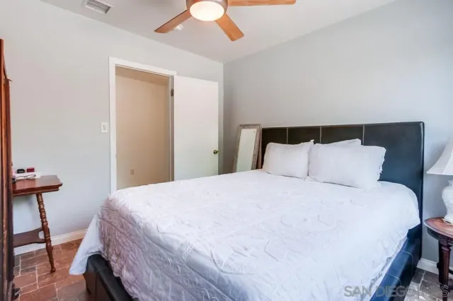 a bedroom with a bed and a dresser