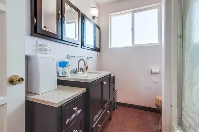 a utility room with sink dryer and washer