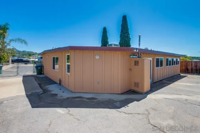 a view of a house with roof and potted plants