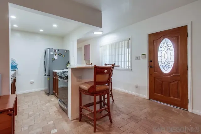 a view of a dining room with furniture and a mirror