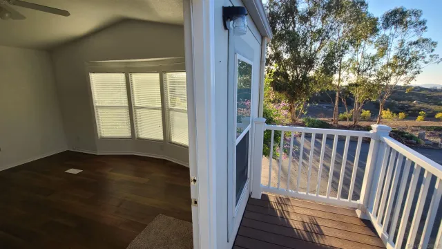 a view of an empty room with windows and closet