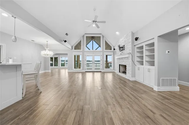 a view of an empty room with a fireplace and a window