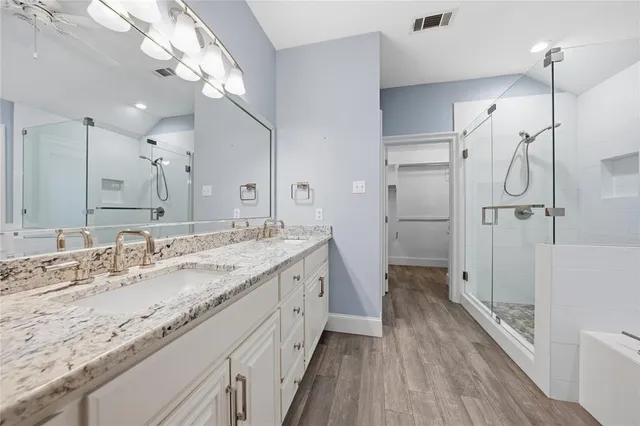a bathroom with a bathtub and shower