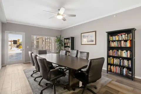 a view of a dining room with furniture and a book shelf