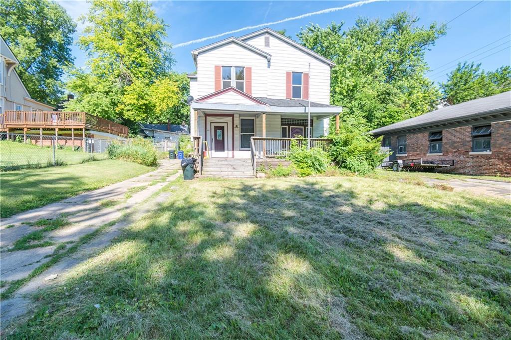 a view of a house with backyard sitting area and garden
