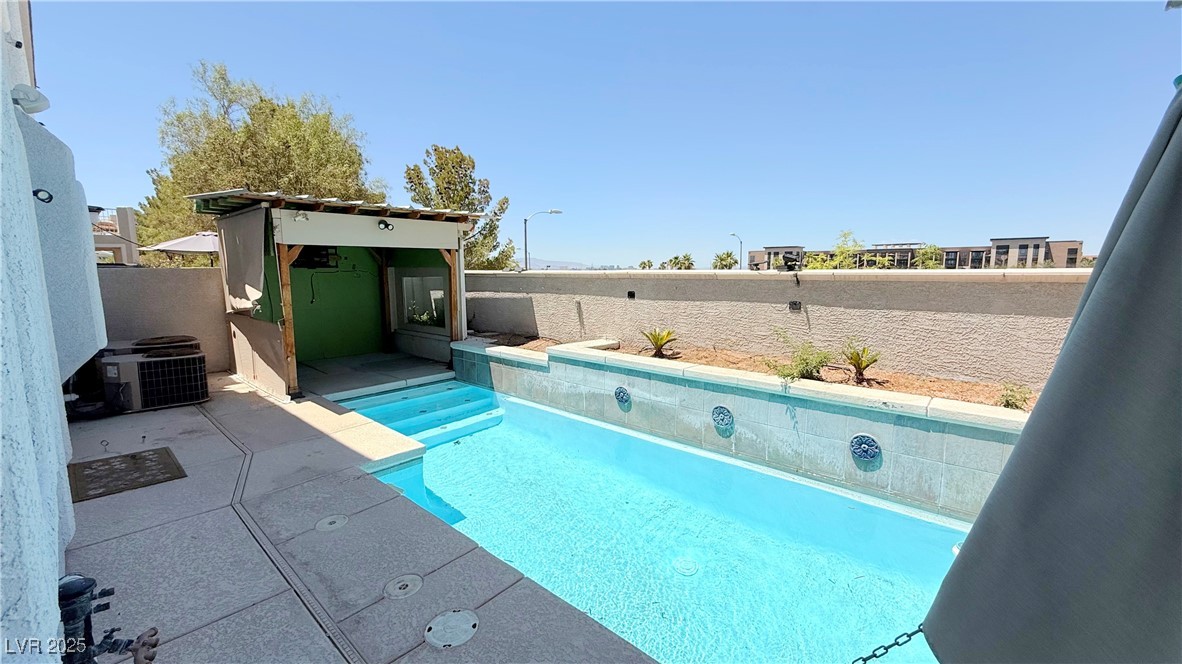 2428 Devotion Ridge Drive Henderson, NV 89052 - Photo 14 of 31 View of swimming pool with a fenced backyard