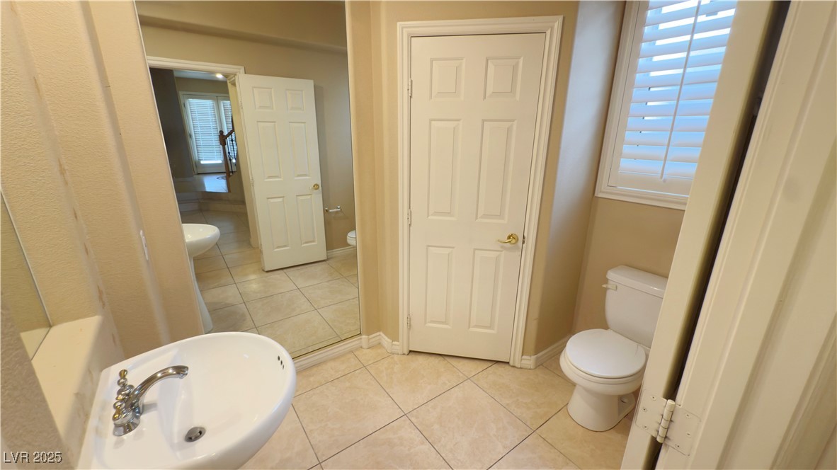2428 Devotion Ridge Drive Henderson, NV 89052 - Photo 21 of 31 Bathroom featuring toilet and tile patterned flooring