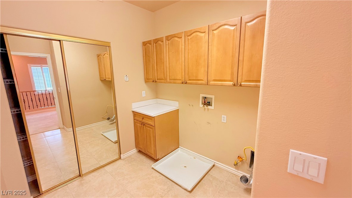 2428 Devotion Ridge Drive Henderson, NV 89052 - Photo 24 of 31 Laundry room featuring hookup for a washing machine, cabinet space, and light tile patterned floors