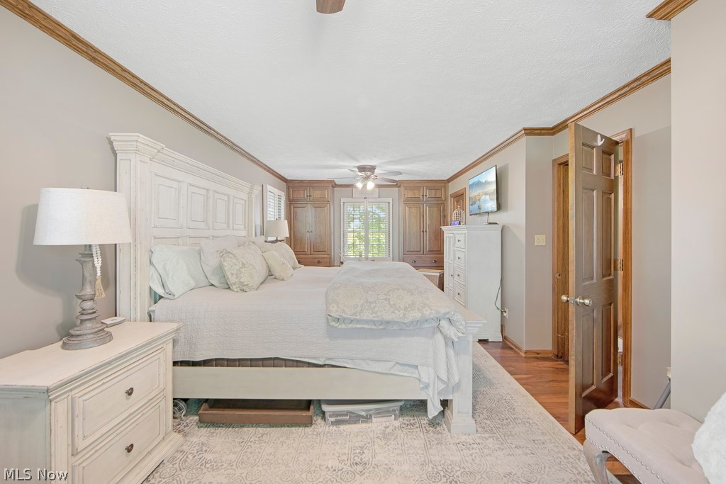 2547 Georgetown-Damascus Road Beloit, OH 44609 - Photo 23 of 49 Bedroom with ceiling fan, light hardwood / wood-style floors, and crown molding