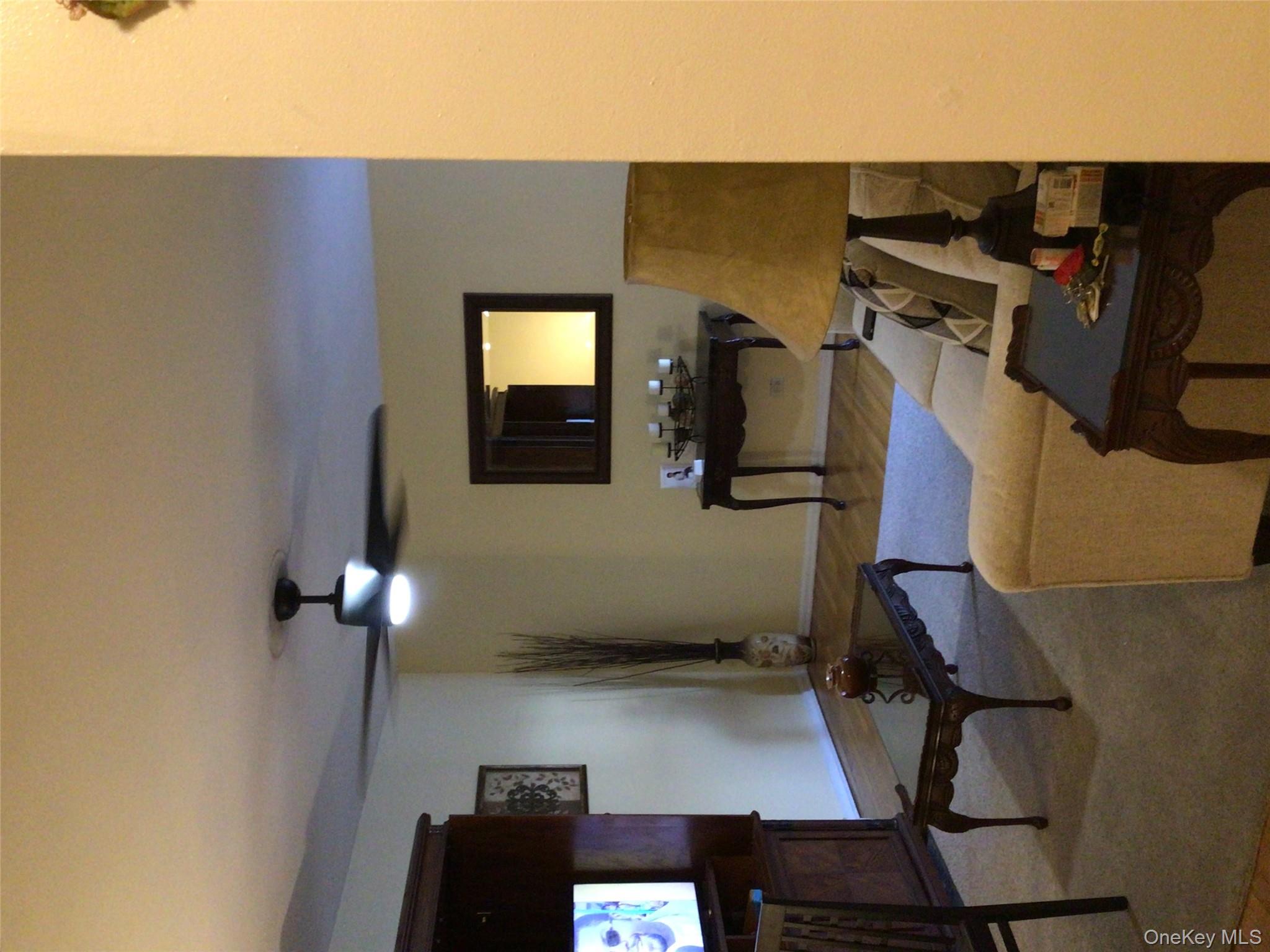 83-05 98th Street, Unit 5B Queens, NY 11421 - Photo 11 of 12 a living room with furniture and a flat screen tv