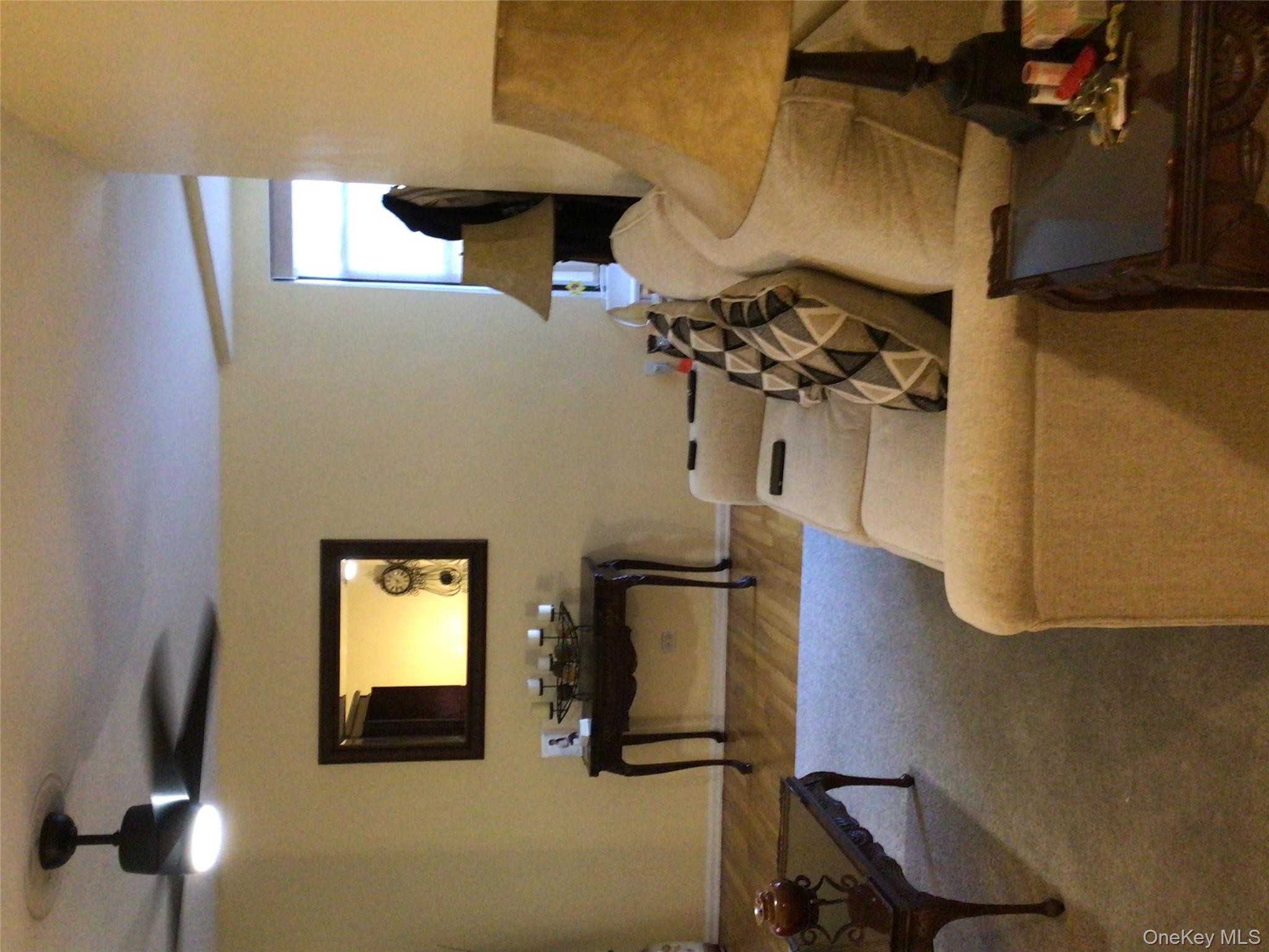 83-05 98th Street, Unit 5B Queens, NY 11421 - Photo 12 of 12 a living room with furniture and a flat screen tv