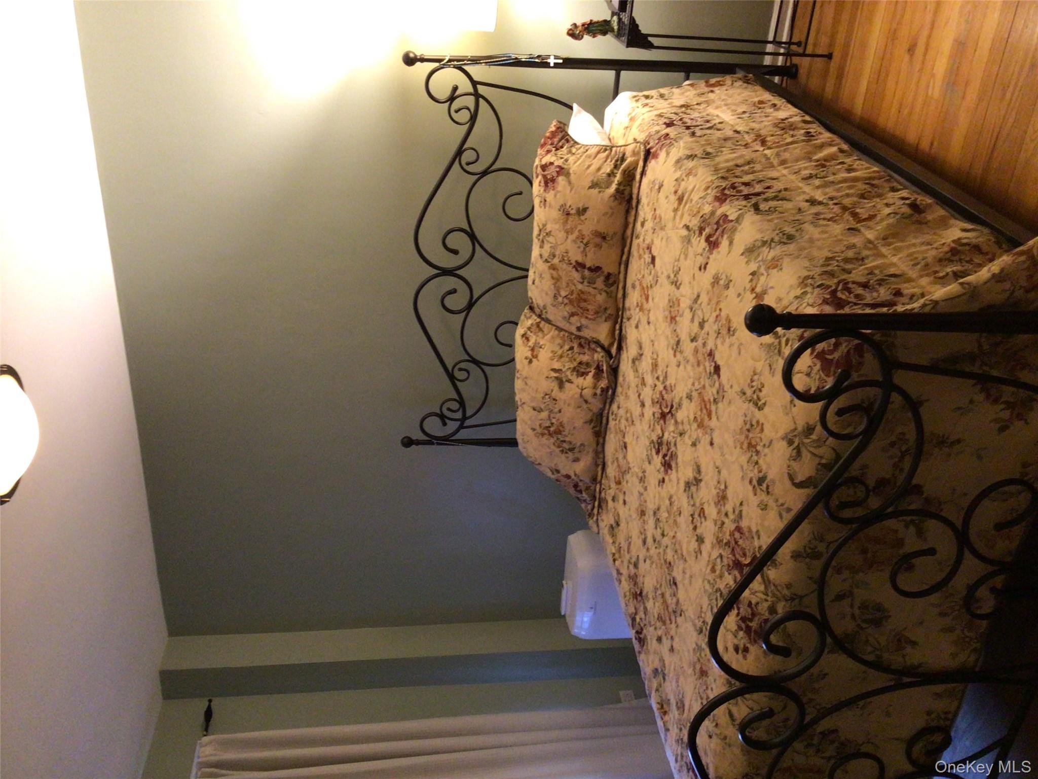 83-05 98th Street, Unit 5B Queens, NY 11421 - Photo 4 of 12 a bedroom with a bed and wooden floor