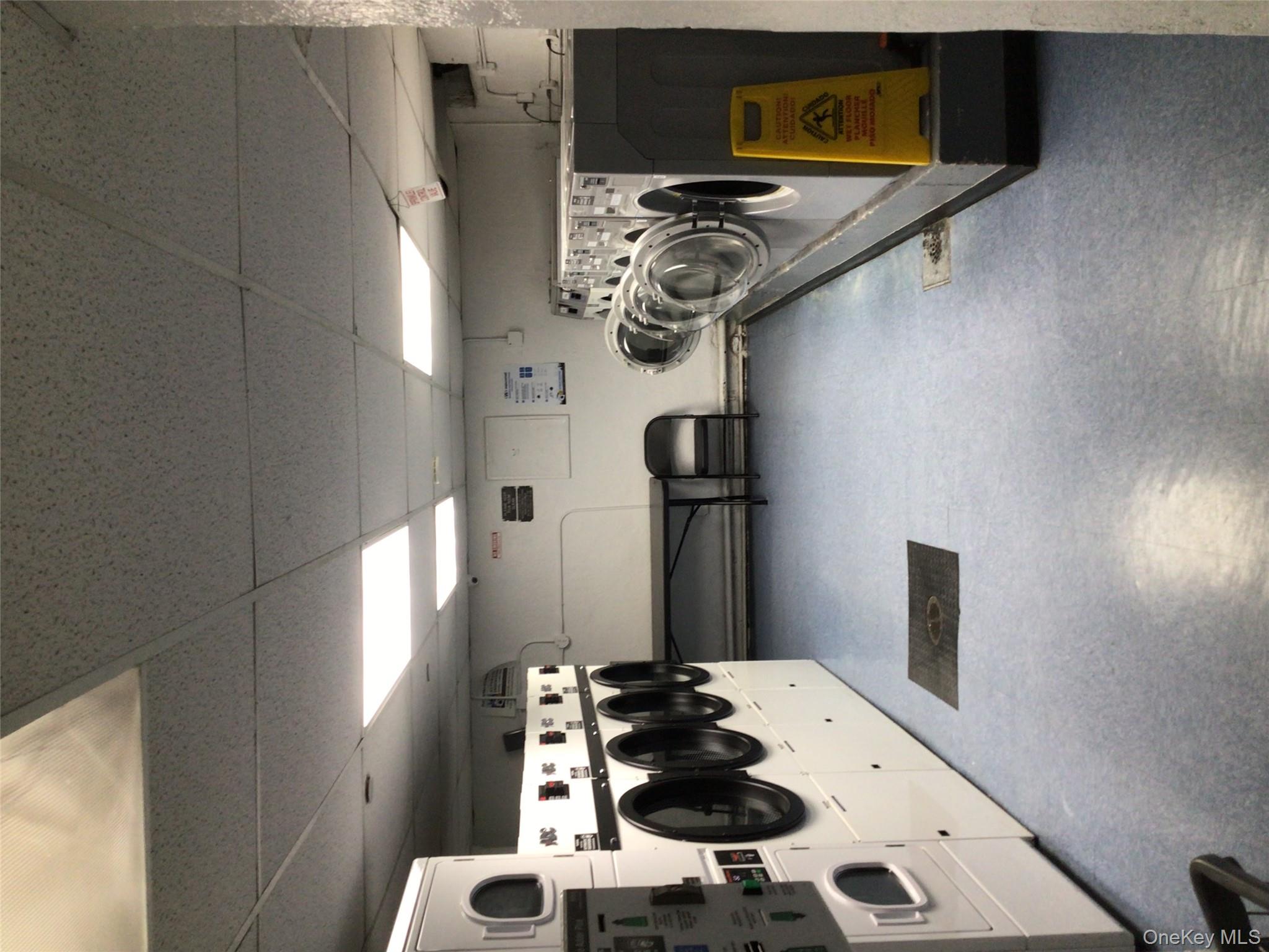 83-05 98th Street, Unit 5B Queens, NY 11421 - Photo 5 of 12 a utility room with cars and parked cars