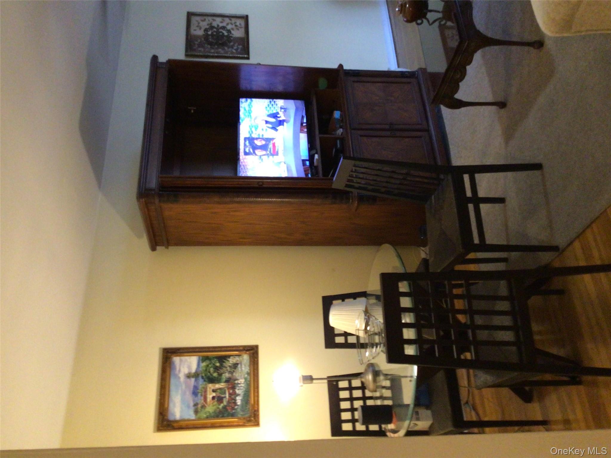 83-05 98th Street, Unit 5B Queens, NY 11421 - Photo 6 of 12 a living room with furniture and a flat screen tv