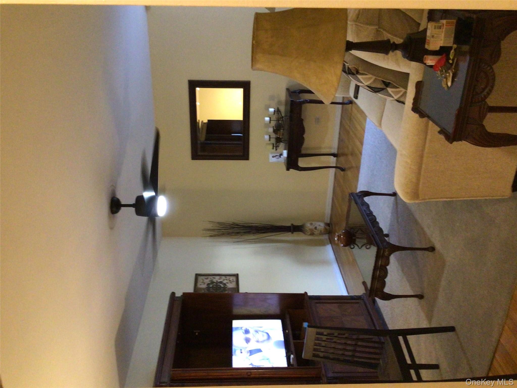 83-05 98th Street, Unit 5B Queens, NY 11421 - Photo 7 of 12 a living room with furniture and a flat screen tv