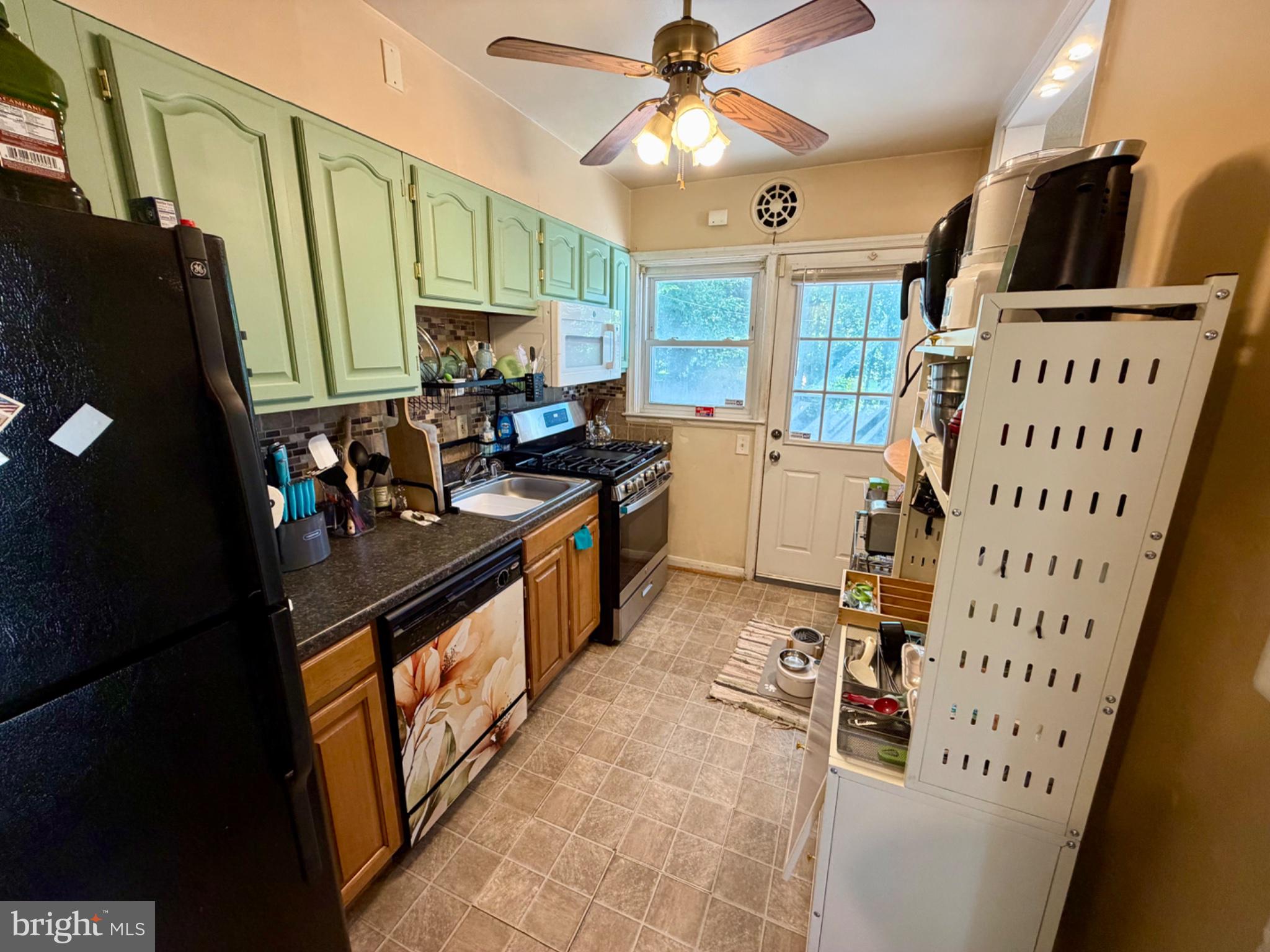 601 Braeside Road Baltimore, MD 21229 - Photo 6 of 19 a kitchen with granite countertop a stove a sink dishwasher and a microwave