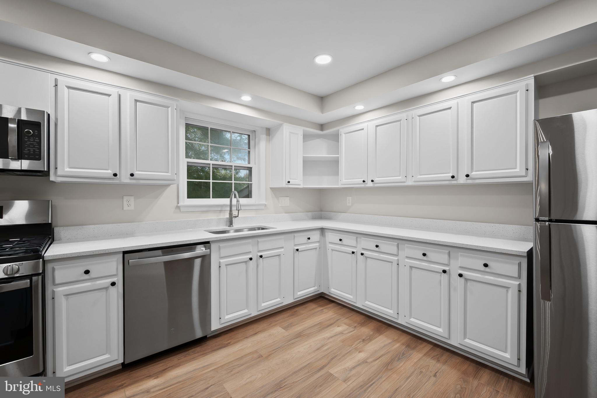 19420 Olney Mill Road Olney, MD 20832 - Photo 11 of 44 a kitchen with white cabinets sink and white appliances