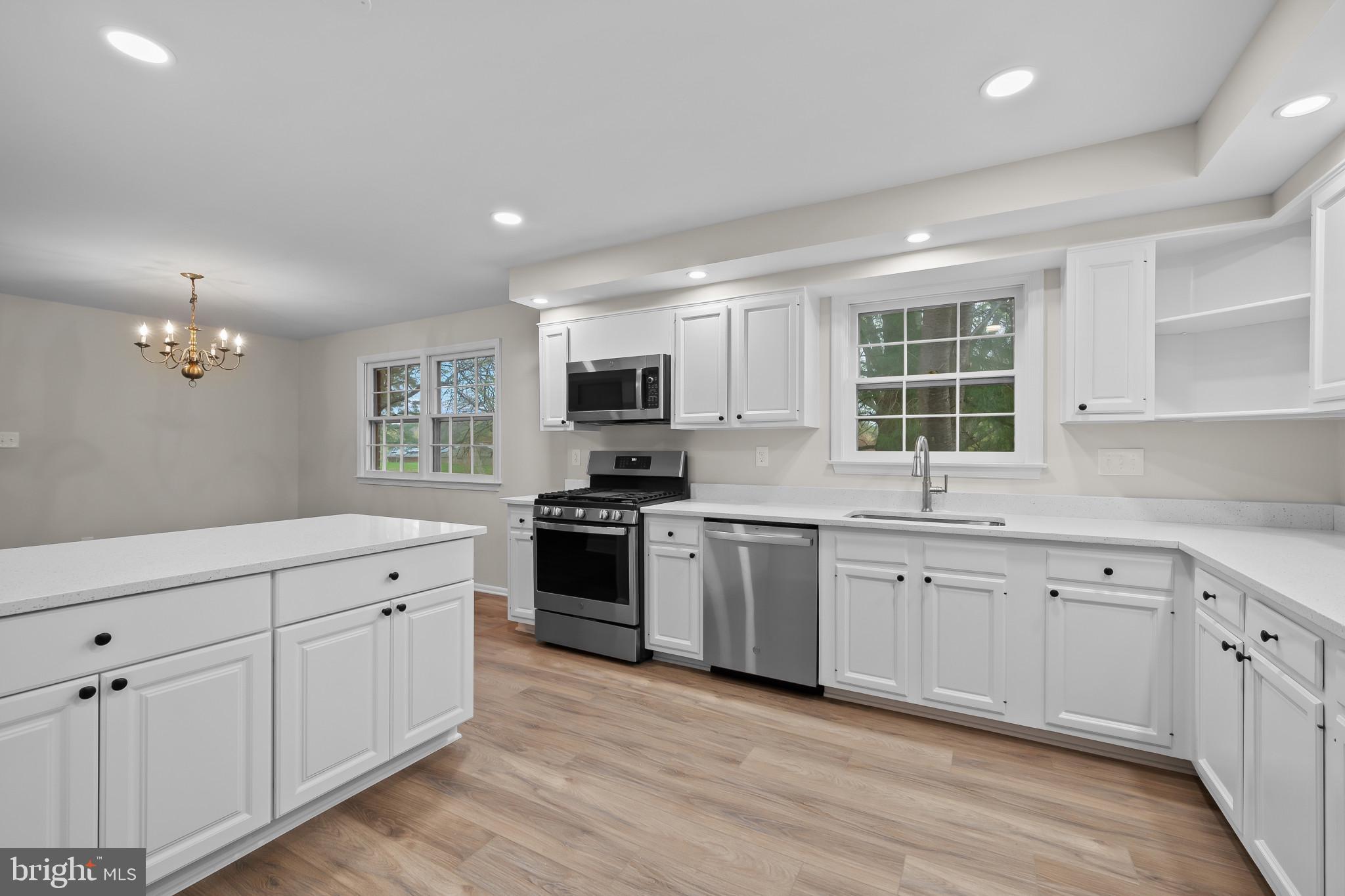 19420 Olney Mill Road Olney, MD 20832 - Photo 12 of 44 a kitchen with granite countertop white cabinets and stainless steel appliances