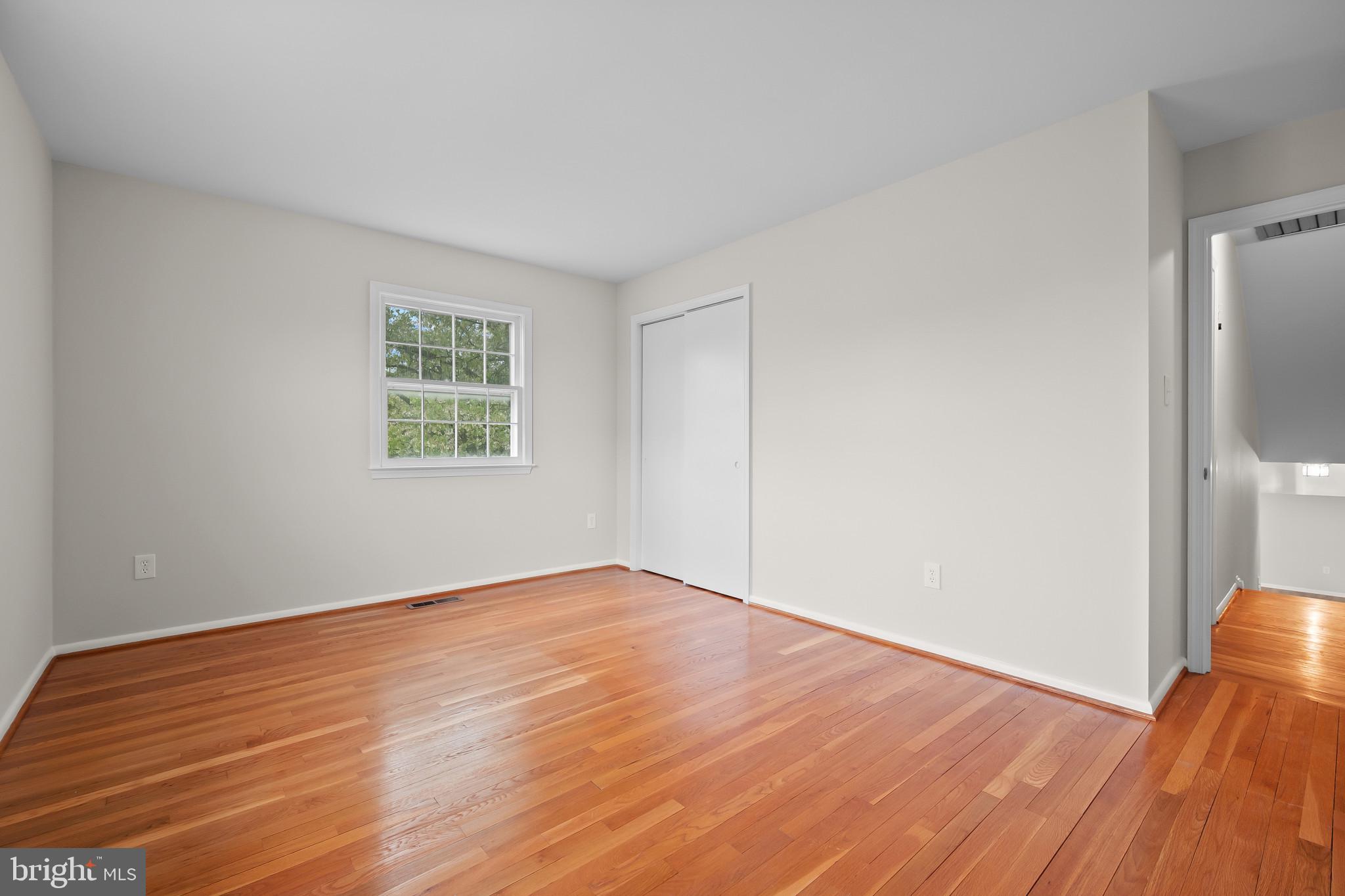 19420 Olney Mill Road Olney, MD 20832 - Photo 16 of 44 an empty room with wooden floor and a window
