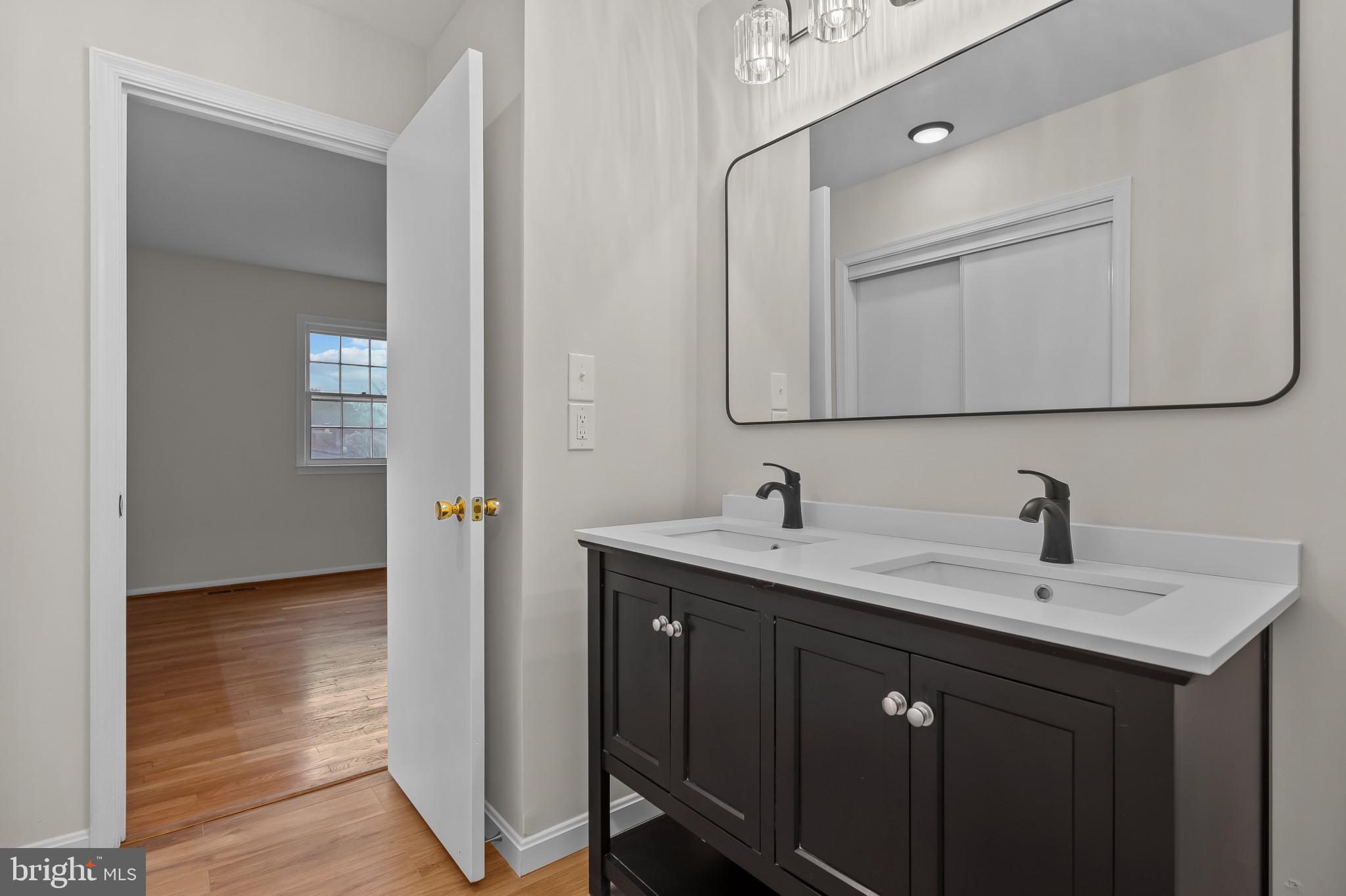 19420 Olney Mill Road Olney, MD 20832 - Photo 21 of 44 a bathroom with a sink and a mirror