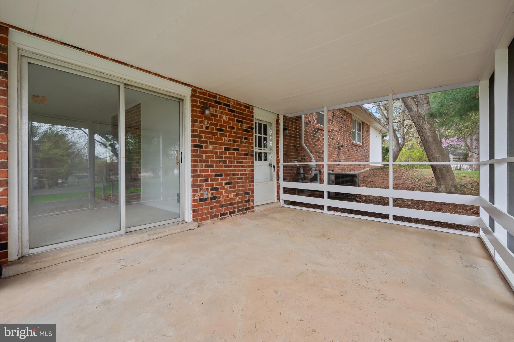 19420 Olney Mill Road Olney, MD 20832 - Photo 34 of 44 an empty room with sliding door and wooden floor