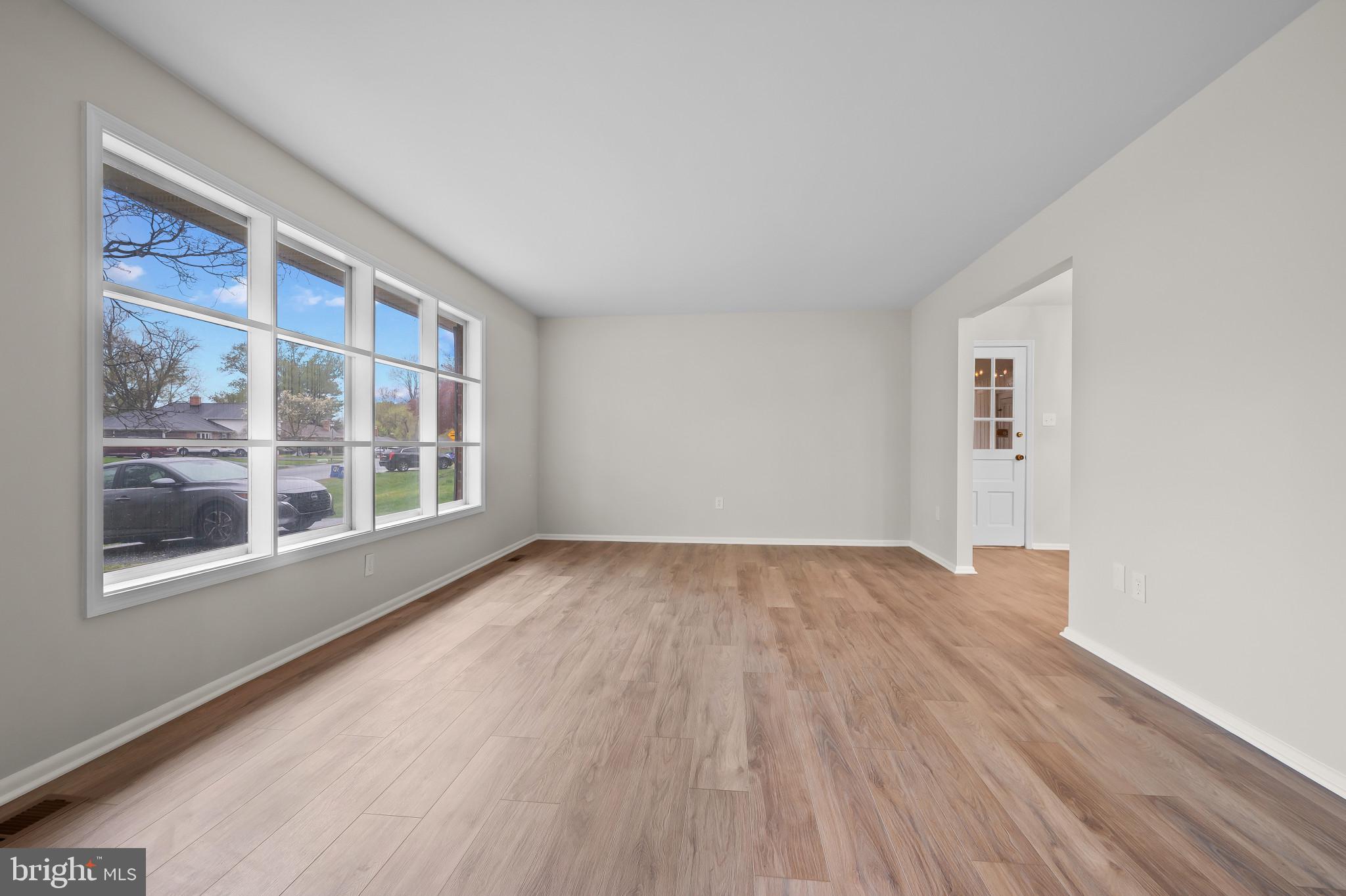 19420 Olney Mill Road Olney, MD 20832 - Photo 4 of 44 a view of an empty room with wooden floor and a window