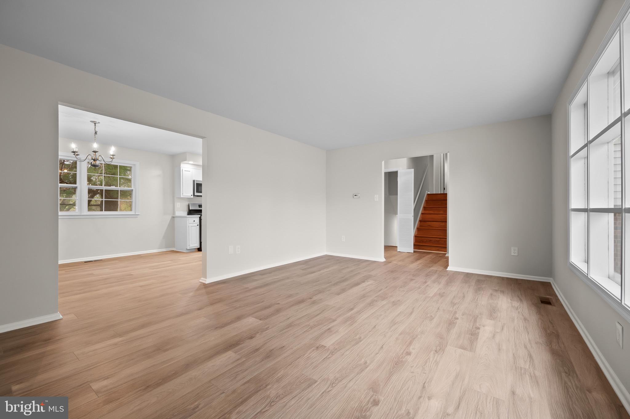 19420 Olney Mill Road Olney, MD 20832 - Photo 6 of 44 an empty room with wooden floor and windows