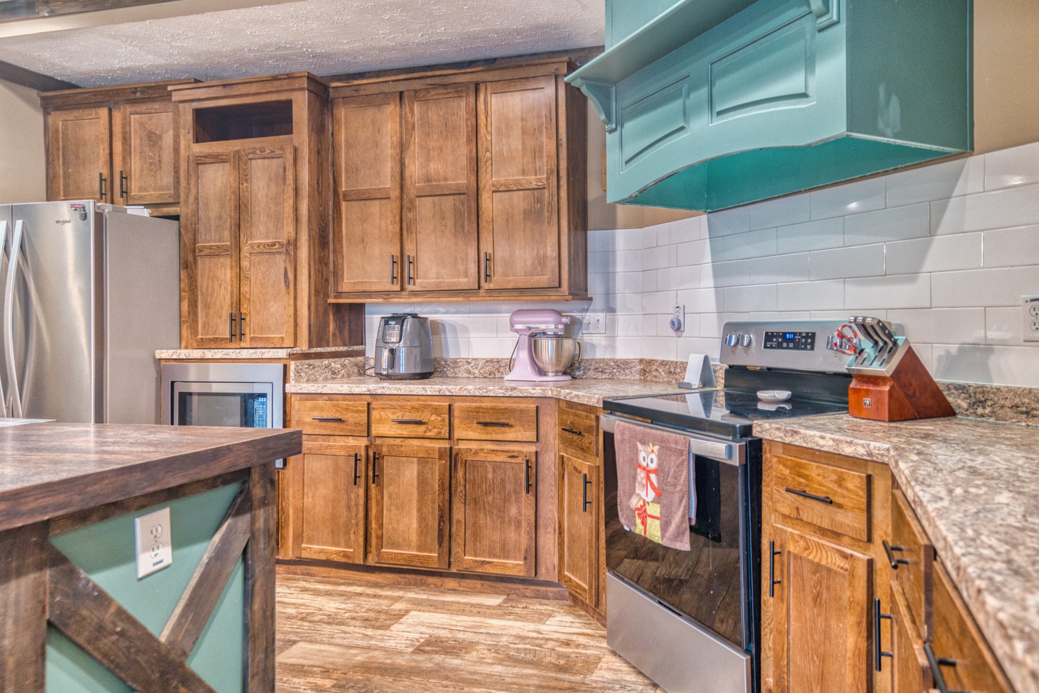721 Spa Road Lewisburg, KY 42256 - Photo 28 of 56 a kitchen with stainless steel appliances granite countertop a refrigerator a sink dishwasher a stove and white countertops with wooden floor