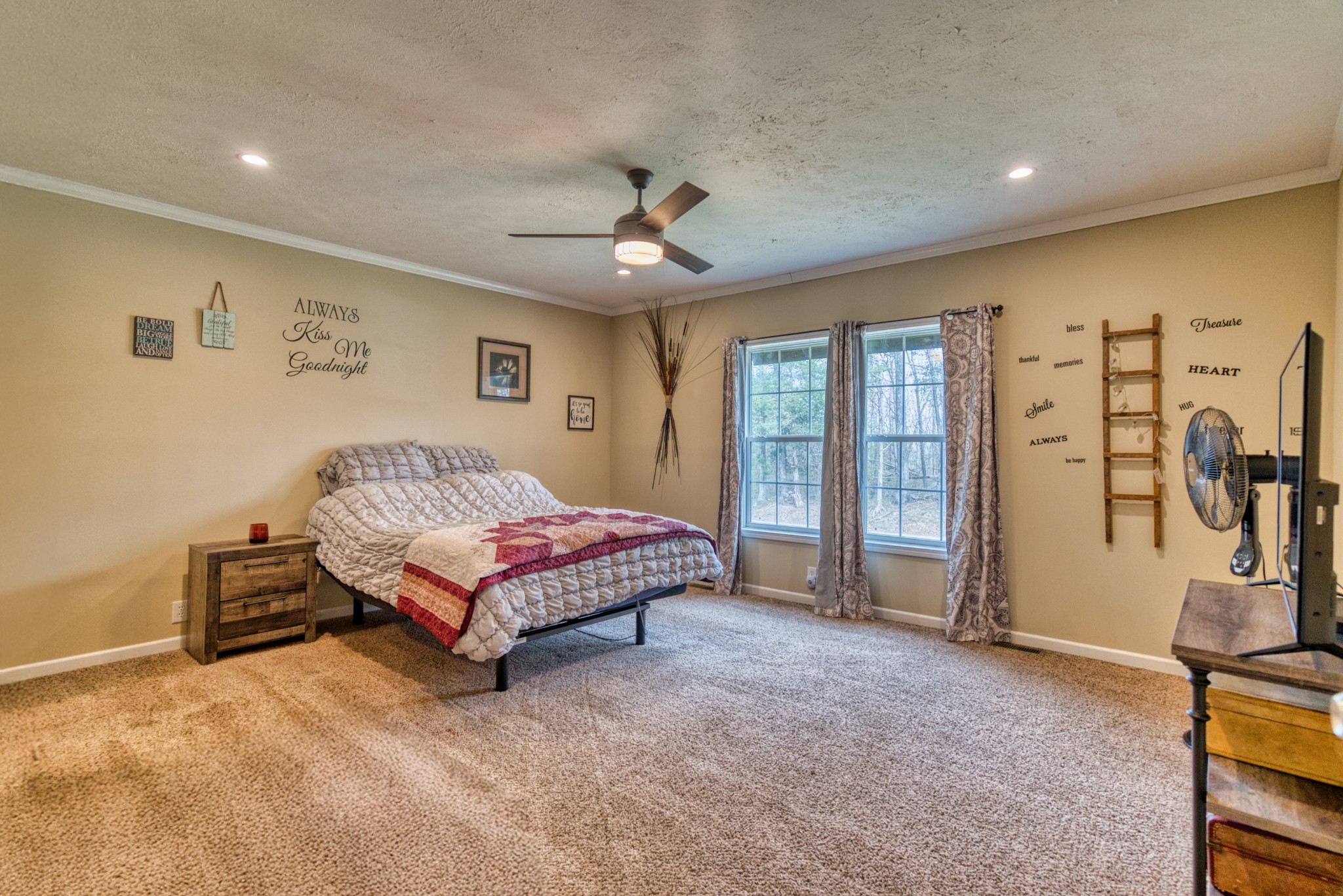 721 Spa Road Lewisburg, KY 42256 - Photo 36 of 56 a spacious bedroom with a bed and a chandelier