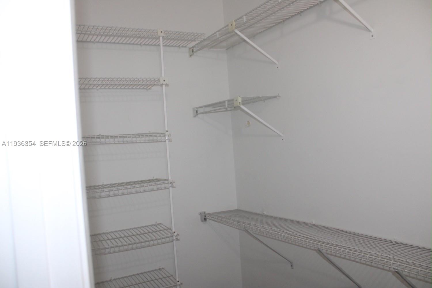 8925 Springtree Lakes Drive Sunrise, FL 33351 - Photo 12 of 19 a view of an empty walk in closet
