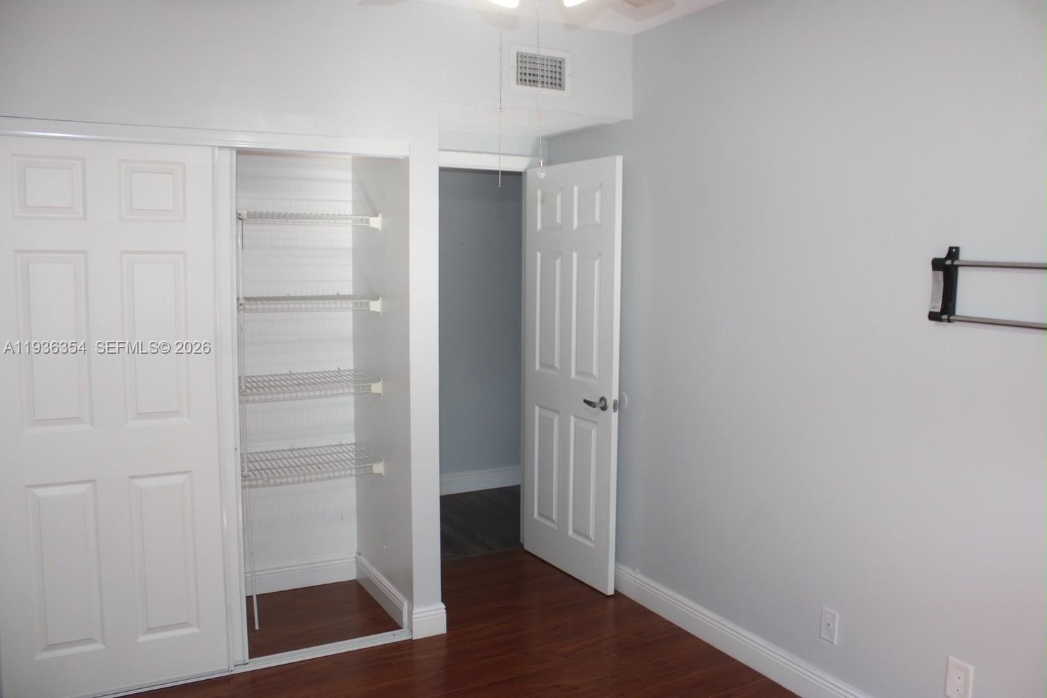 8925 Springtree Lakes Drive Sunrise, FL 33351 - Photo 13 of 19 a view of walk in closet with empty racks