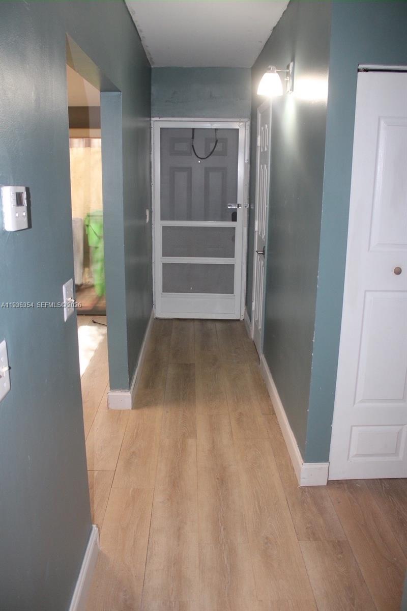 8925 Springtree Lakes Drive Sunrise, FL 33351 - Photo 10 of 19 wooden floor in a hall with an entryway