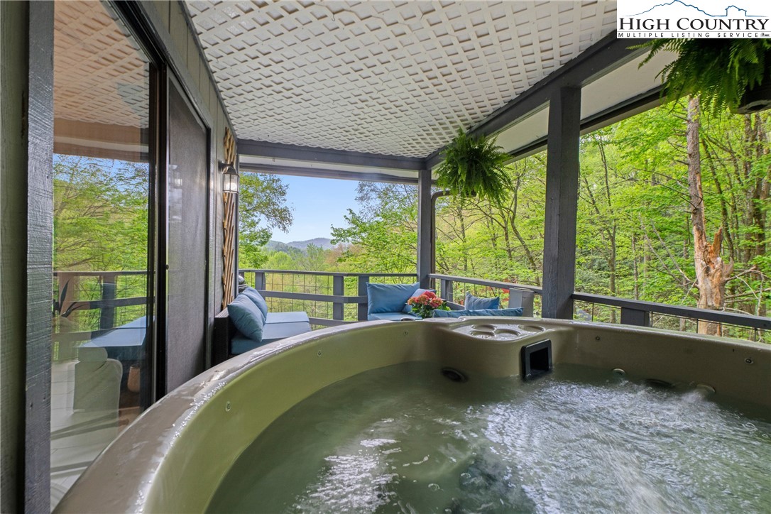 252 Hemlock Road Banner Elk, NC 28604 - Photo 1 of 50 a room with a large window and swimming pool