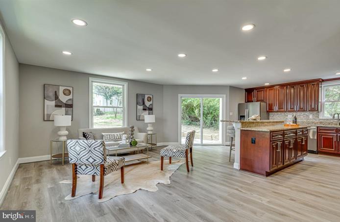 4105 30th Street Mount Rainier, MD 20712 - Photo 11 of 98 a living room with stainless steel appliances granite countertop furniture wooden floor and a window