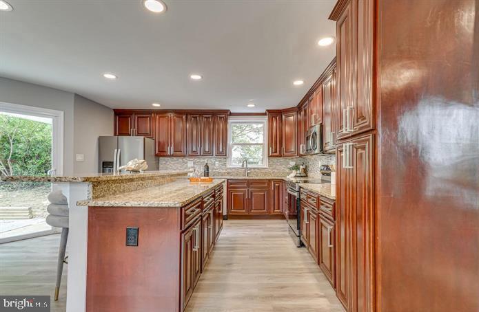 4105 30th Street Mount Rainier, MD 20712 - Photo 16 of 98 a kitchen with stainless steel appliances granite countertop lots of counter top space and wooden floor