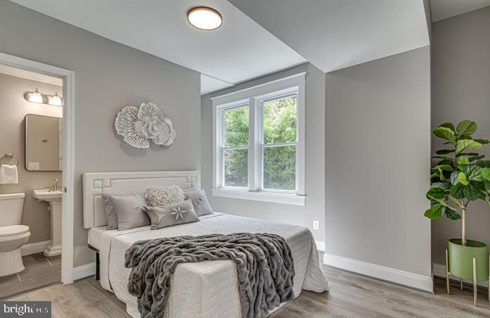 4105 30th Street Mount Rainier, MD 20712 - Photo 22 of 98 a bedroom with a bed and a potted plant