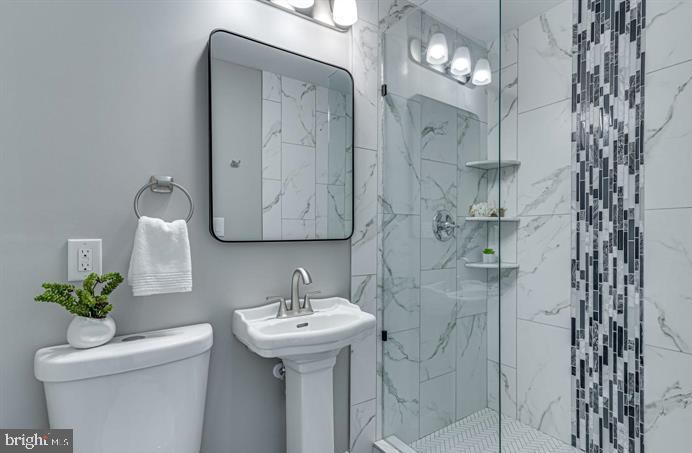 4105 30th Street Mount Rainier, MD 20712 - Photo 23 of 98 a bathroom with a sink toilet and shower