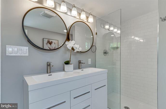 4105 30th Street Mount Rainier, MD 20712 - Photo 27 of 98 a bathroom with a sink and a mirror