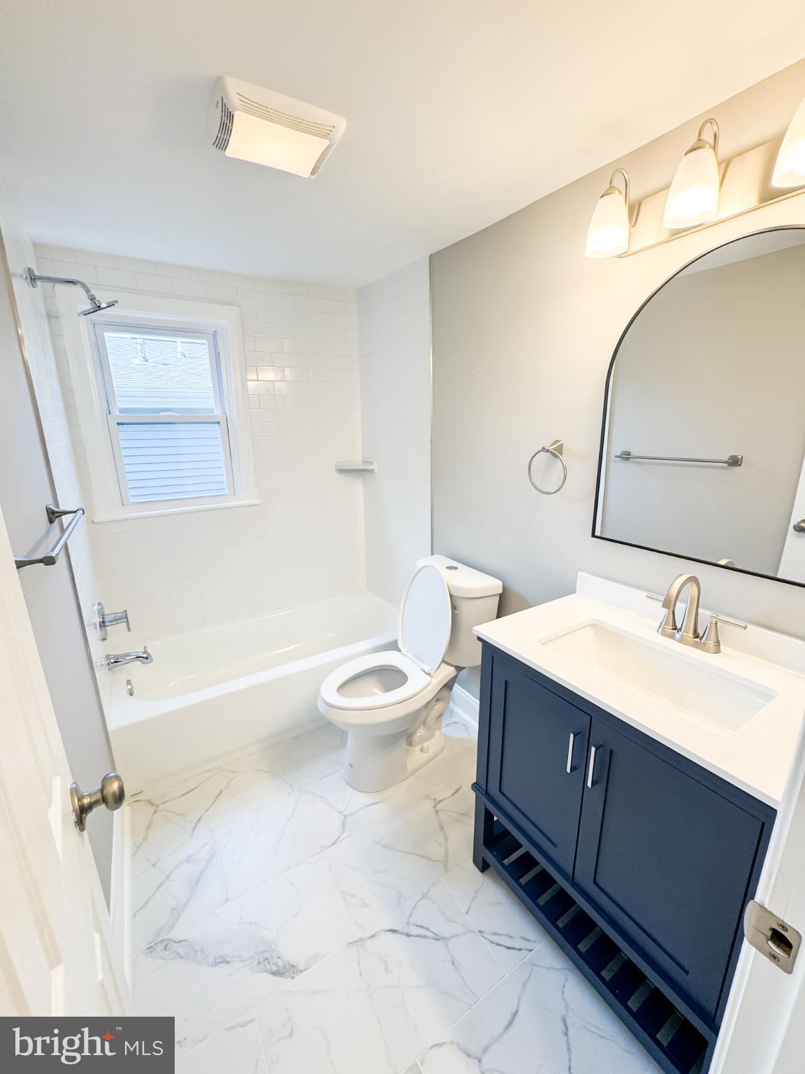 4105 30th Street Mount Rainier, MD 20712 - Photo 31 of 98 a bathroom with a sink a toilet and a mirror