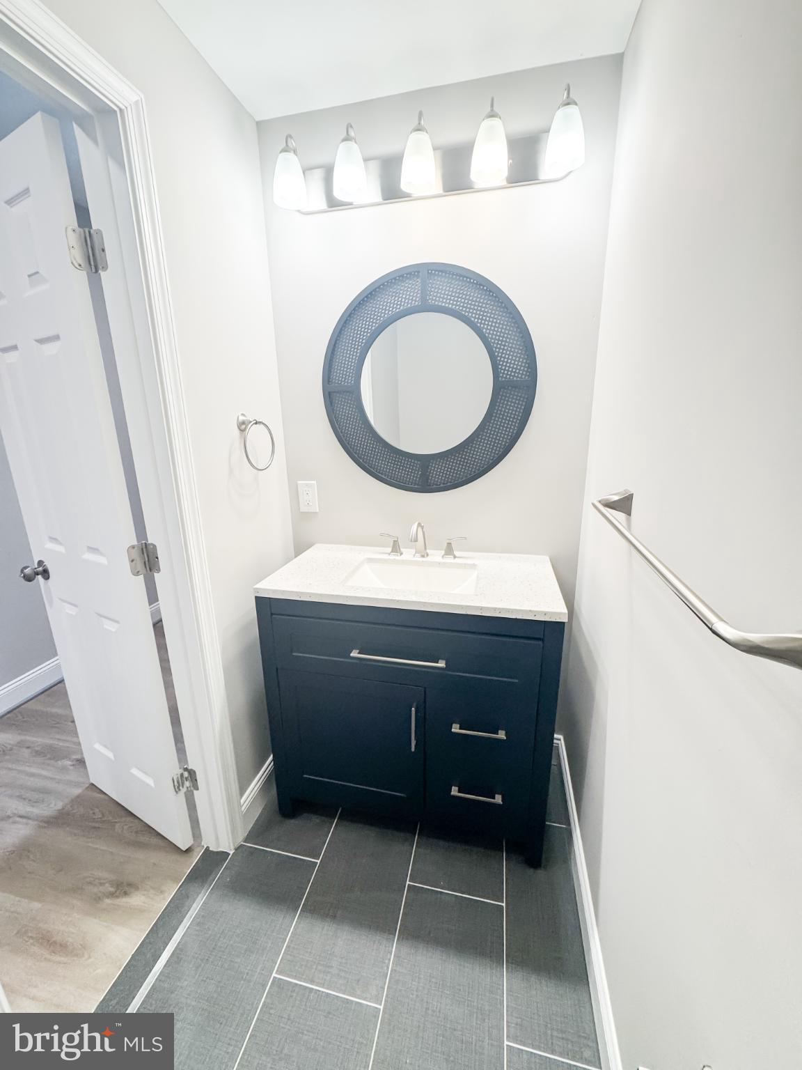 4105 30th Street Mount Rainier, MD 20712 - Photo 53 of 98 a bathroom with a sink a toilet and a mirror