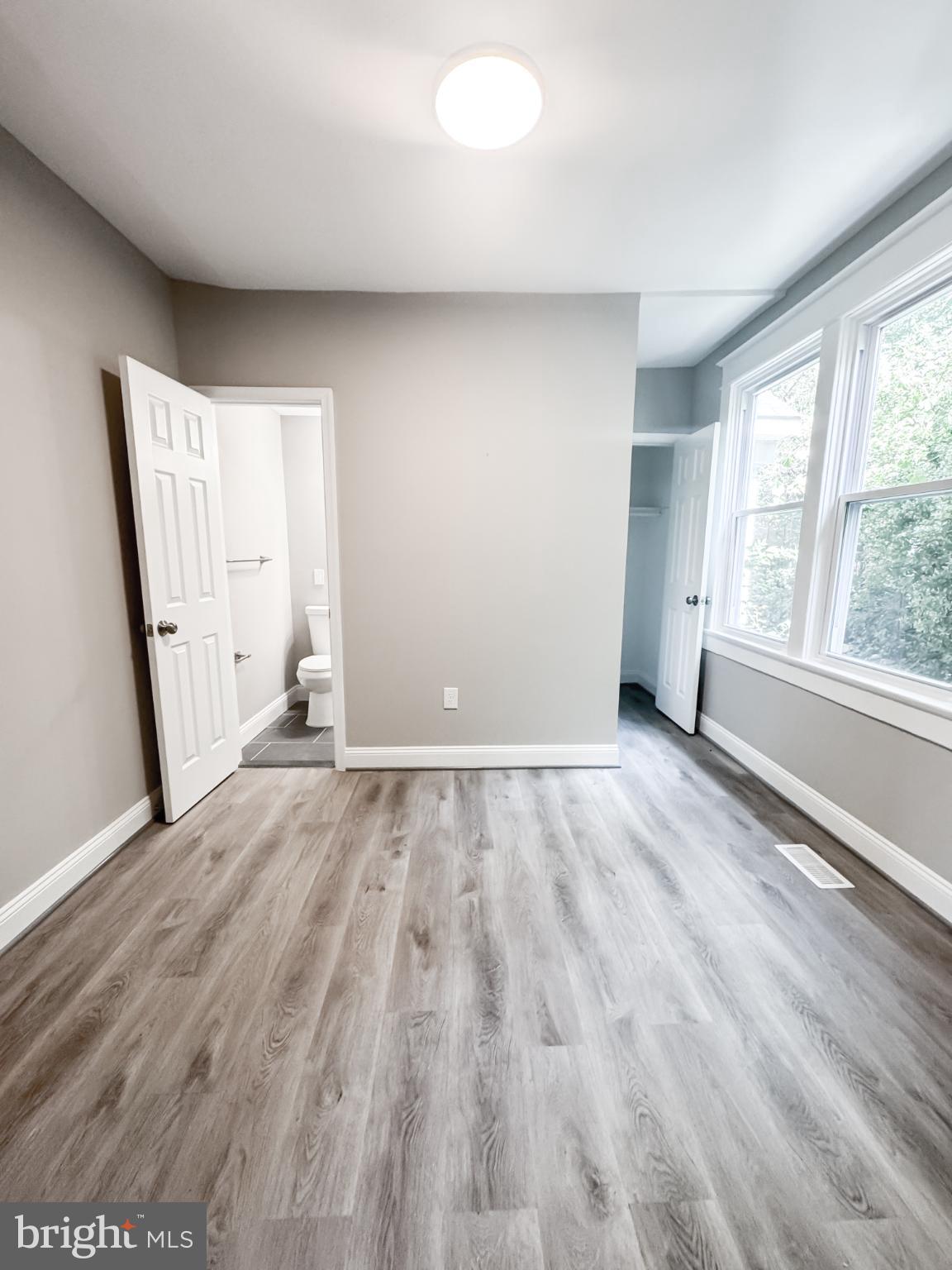 4105 30th Street Mount Rainier, MD 20712 - Photo 77 of 98 wooden floor in an empty room with a window