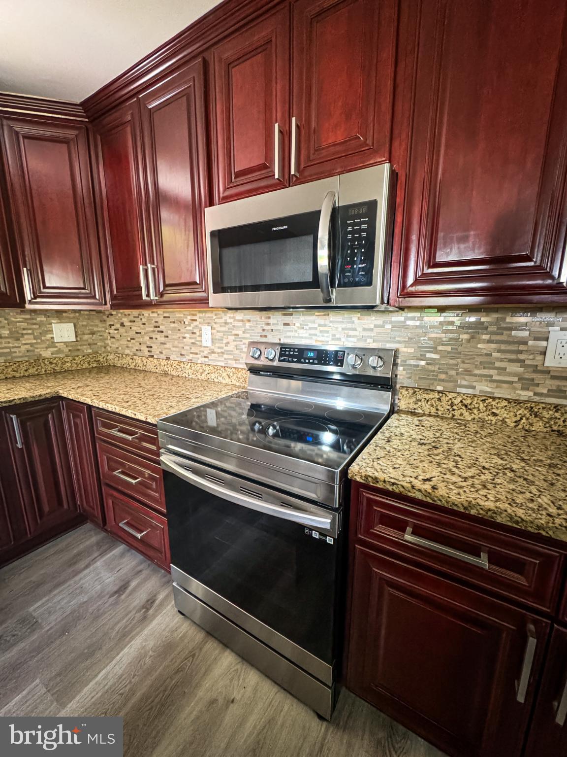 4105 30th Street Mount Rainier, MD 20712 - Photo 78 of 98 a kitchen with granite countertop wooden cabinets and stainless steel appliances